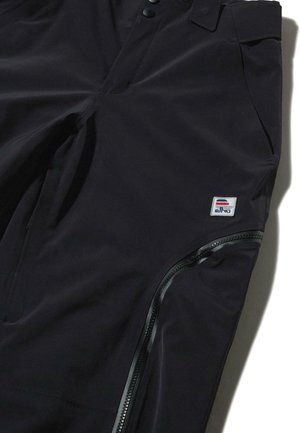 Schwarze wasserdichte Hose mit einem eleganten Design, ausgestattet mit einer Reißverschlusstasche und einem Logo-Patch, gefertigt aus einem glatten, strapazierfähigen Stoff.