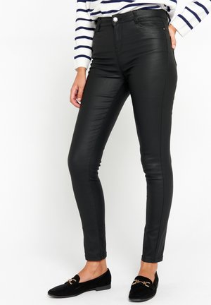 COATED SKINNY - Pantalones - black