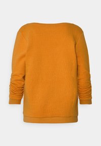 Oranžová textured bavlněná mikina s dlouhými rukávy, širokým výstřihem a nařasenými detaily na rukávech. Žádné viditelné vzory ani akcenty.