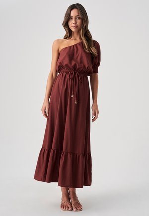 Maxi dress in deep rust color, featuring an off-shoulder design, elastic waistband, and ruffled hem. Made of soft fabric with smooth texture.