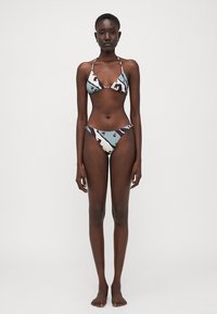 Bikini su trikampiu viršumi ir struktūruotais apačioje, su šviesiai mėlynu pagrindu ir abstrakčiomis tamsiomis bei raudonomis rašėmis, pagamintas iš lygios medžiagos.