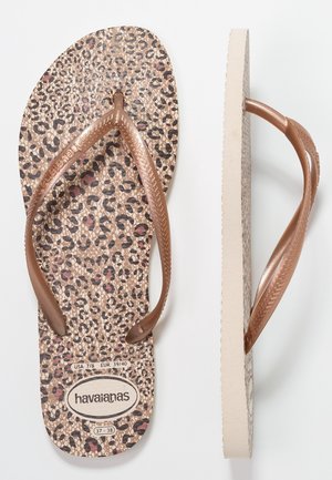 Sandales tongs avec semelles imprimé léopard et brides métalliques bronze, affichant les étiquettes de taille USA 7/8, EUR 39/40, et la marque "havaianas."