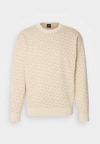 Pull beige à col ras du cou avec un motif géométrique subtil sur l'ensemble et des poignets et un ourlet côtelés, avec l'étiquette BOSS à l'intérieur du col.
