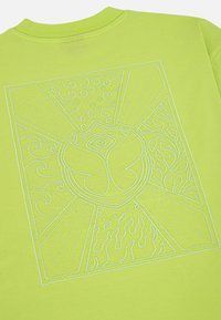 Limoengroene t-shirt met een textuur geëmbleerde design van spiralen en vlammen, centrisch rond een cirkelvormig symbool met een oog.
