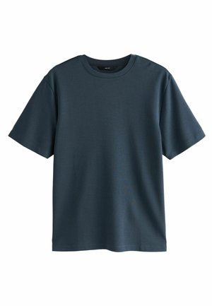 Tamno tirkizna kratka majica od glatkog pamuka, s klasičnom okruglom izrezom i opuštenim krojem. Minimalistički dizajn, bez uzoraka.