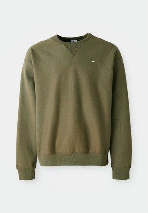 Olive green Nike sweatshirt with a crew neckline and ribbed cuffs, displayed against a plain white background.