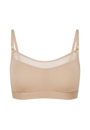 Nude bra with a soft, stretchy fabric. Features sheer mesh panels and adjustable straps with gold-tone hardware. Smooth, seamless design.