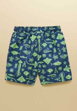 Marineblauwe shorts met een elastische tailleband en een felgroen zeedierenpatroon met onder andere vissen, schildpadden, inktvissen, zeesterren en krabben.