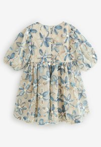 Sheer beige dress with blue and white flower patterns and puffed sleeves, decorated with small shiny sequins on each flower center.
