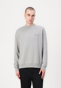 Gray sweatshirt made of cotton blend, features a crew neck, long sleeves, ribbed cuffs, and a small black logo on the chest.
