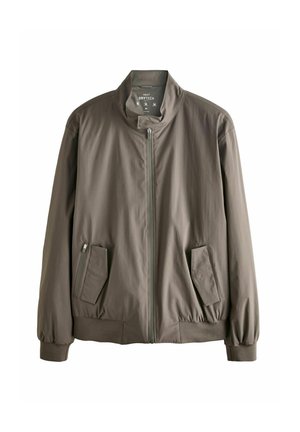 Chaqueta bomber gris con un alto cuello, cierre frontal y dos bolsillos laterales. Hecha de un tejido ligero y texturizado con puños elásticos.