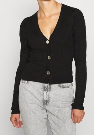 Black ribbed sweater with a deep V-neck, long sleeves, and four silver buttons down the front. Fitted design with textured fabric.