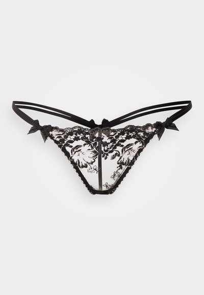 String en dentelle noire avec motifs floraux, maille transparente, accents en satin et doubles bretelles avec des nœuds sur les côtés. Détail à bords festonnés.