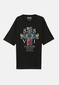 Black oversized t-shirt featuring a colorful graphic design with a butterfly, roses, and text, made of soft cotton fabric.