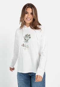 Hvid langærmet hættetrøje med et blomstermotiv i dæmpede grønne og blå nuancer. Blød struktur med snor i hætten og en afslappet pasform.