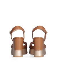 Brown faux leather platform sandals with a wide heel and ankle strap. The heel features a textured gold accent on a contrasting base.