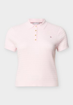 Light pink short-sleeve knitted polo shirt with textured diamond pattern, four golden buttons, and small embroidered logo on the chest.
