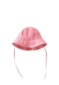 Cappello a secchiello rosa realizzato in morbido tessuto, con motivi a conchiglia bianchi, una larga visiera e lacci regolabili su ciascun lato.