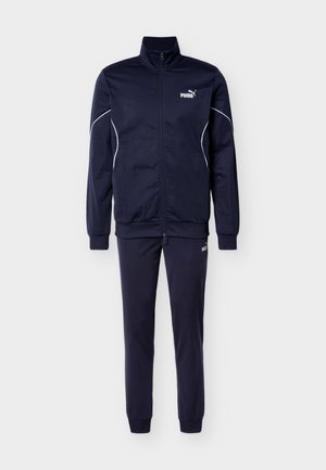 Navy tracksuit featuring a zipped jacket with long sleeves, white accents, and matching pants with elastic cuffs, made from lightweight fabric.
