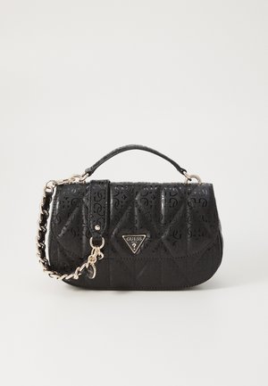 Black quilted handbag with a short handle and gold chain strap, featuring a triangular Guess logo on the front flap.