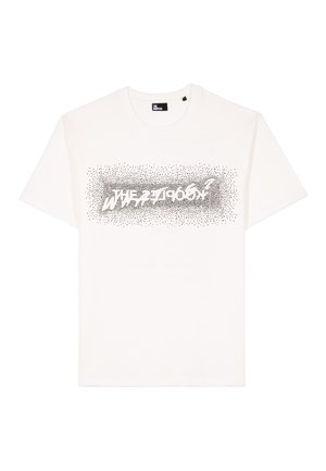 Balta medvilninė marškinėlių užsakyta su juodu taškiniu piešiniu, ant krūtinės dideliu, moderniu šriftu užrašyta "ZEBRA".