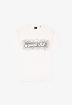 White cotton t-shirt featuring a black dotted graphic print reading "THE ZEBRA" across the chest in a bold, modern font.