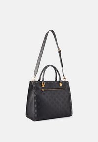 Černá kožená kabelka se strukturovaným tvarem, zdobená zlatým zipem a kováním. Povrch vystavuje jemný monogramový vzor.