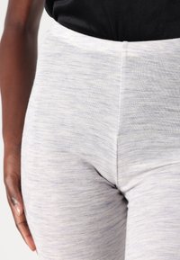 Light gray leggings with a fine melange texture, featuring a high waistband and smooth fabric that contours to the shape of the legs.