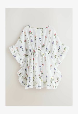 Valge, lillemustriga ja kerge pluus. Omadused on volangidega varrukad ja serv ning vöö peal lips. Valmistatud pehmest ja hingavast kangast.