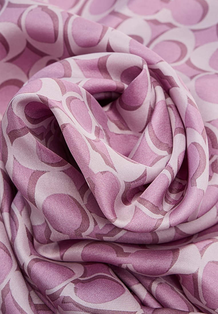 Écharpe violette en tissu doux présentant un motif brillant de cercles imbriqués dans différentes teintes de rose.