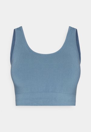Sømløs blå crop top laget av myk, elastisk stoff. Den har en bred, rund halslinje og tykke stropper med ribbet tekstur.