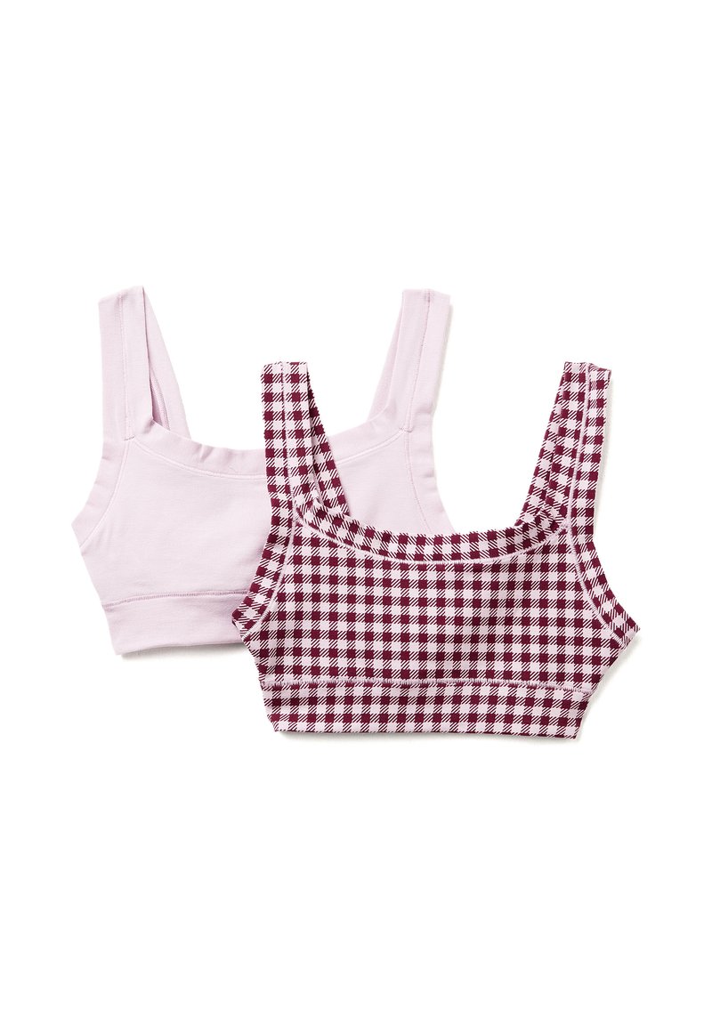 Due top crop: uno in un rosa chiaro solido, l'altro in un motivo a quadri bianco e bordeaux. Entrambi hanno spalline larghe e un design aderente.