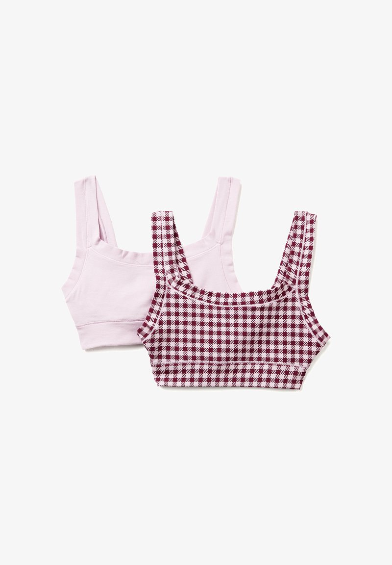 Dwa topy crop: jeden w jednolitym jasnoróżowym kolorze, a drugi w maroonowy i biały wzór w kratkę. Oba mają szerokie ramiączka i dopasowany krój.