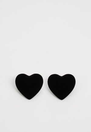 Two black velvet heart-shaped earrings on a plain white background, positioned side by side.