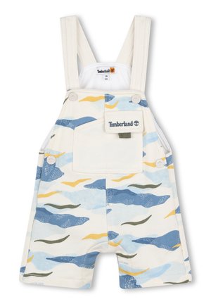 Salopette blanche avec un motif de vagues bleu clair, vert et jaune. Comprend des bretelles ajustables, une poche avant et un patch logo Timberland.