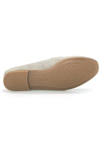 Gray suede flat shoe with a rubber sole, featuring a wave texture, a beige outsole, and embossed branding "Gabor" on the bottom.
