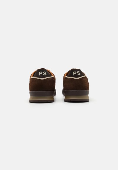 Brown suede sneakers with orange accents, featuring a black heel cap marked "PS," and a textured rubber sole. Simple design, low profile.
