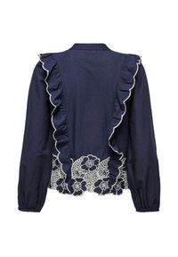 Blouse bleu marine à manches longues avec bordures volantées et détails en dentelle florale blanche le long du dos et de l'ourlet.