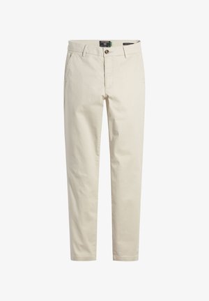 Beige chinos, mis valmistatud pehmest puuvillakangast, klassikalise sirge lõikega, ees nupuga kinnitamine ja kaldus küljetaskud.