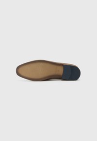 Brown suede shoe sole with a textured design, featuring a blue rubber accent on the heel for added grip and stability.