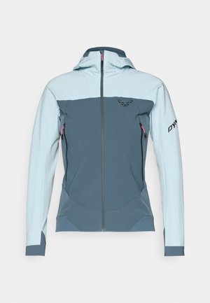 Hettejakke i lys blå og mørk blå, med teksturert stoff, frontglidelås, sidelommer og en logo på armen.