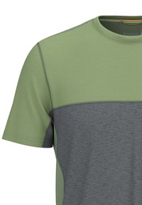 Mans kortärmad skjorta med en ljusgrön topp och mörkgrå botten, med ett texturerat mönster längs sidan och kontrasterande sömnad.