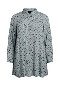 Blusa verde chiara con colletto a bottoni, maniche lunghe e piccolo motivo floreale in bianco e nero. Realizzata in morbido tessuto testurizzato.