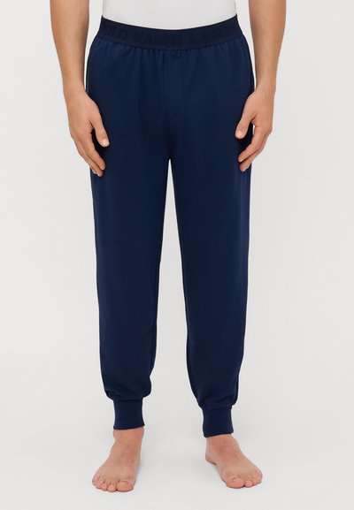 Pantaloni jogging blu navy con cintura elastica caratterizzati dal logo "Polo Ralph Lauren" in rilievo. Vestibilità tapered con orli a costina, realizzati in tessuto morbido.