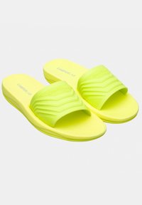 Bright yellow slide sandals with a textured strap and contoured footbed. Made of lightweight, durable material for comfort and flexibility.