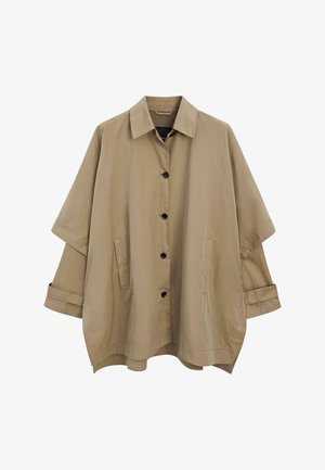 Beige oversized jakke med krave, udstyret med sorte knapper og to forlommer. Glat tekstur, afslappet pasform og oprullede ærmer.