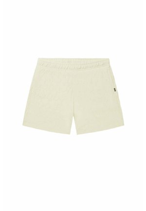 Cream-colored shorts with a textured hexagonal pattern, elastic waistband, and no visible pockets. Soft fabric with a relaxed fit.