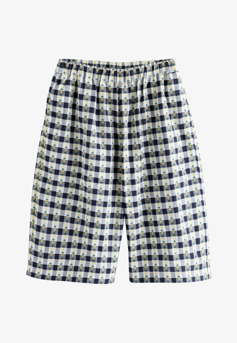Short à carreaux avec des carrés bleu marine et blancs ainsi que des rayures florales verticales jaunes, avec une ceinture élastique.
