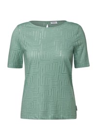 Haut vert clair à manches courtes avec un motif géométrique texturé, présentant un col rond et un petit détail de trou clé au dos.