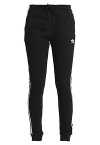 Svarta träningsbyxor i mjukt tyg, med vita sidostripes, dragsko i midjan och en broderad logotyp på vänstra låret.